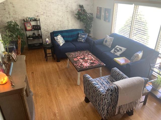 111 Magnolia Ln, Lindenhurst, IL 60046 - living room featuring wood finished floors and brick wall