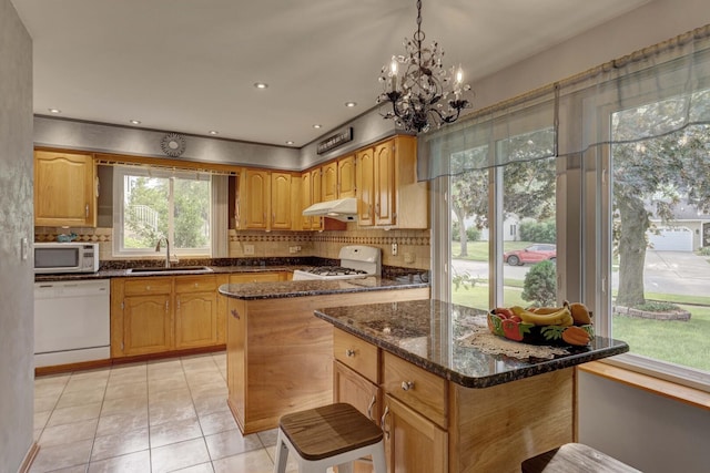 833 Summerfield Dr, Roselle, IL 60172 - kitchen with white appliances, a sink, under cabinet range hood, dark stone counters, and decorative backsplash