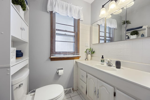 931 Sunset Rd, Wheaton, IL 60189 - bathroom featuring toilet, vanity, tile patterned floors, and decorative backsplash