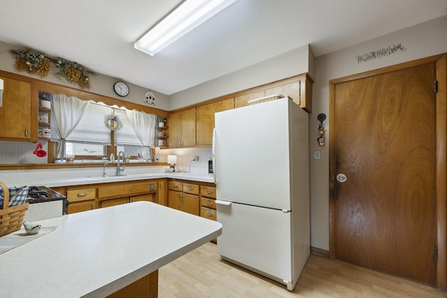 931 Sunset Rd, Wheaton, IL 60189 - kitchen featuring freestanding refrigerator, a sink, light wood-style flooring, light countertops, and tasteful backsplash