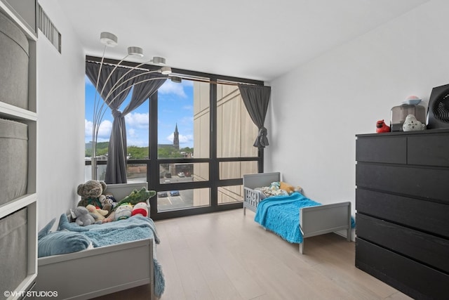 1636 N Wells St Unit 615, Chicago, IL 60614 - bedroom featuring a wall of windows and wood finished floors