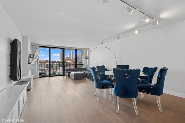 1636 N Wells St Unit 615, Chicago, IL 60614 - dining area with expansive windows, track lighting, and light wood finished floors