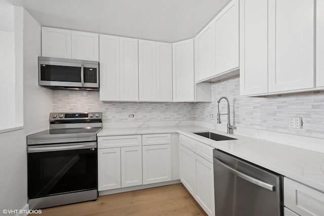 1636 N Wells St Unit 615, Chicago, IL 60614 - kitchen featuring stainless steel appliances, a sink, white cabinetry, and backsplash