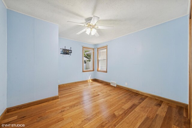 359 N Shady Ln, Elmhurst, IL 60126 - unfurnished room with light wood-type flooring, a ceiling fan, a textured ceiling, baseboards, and ornamental molding