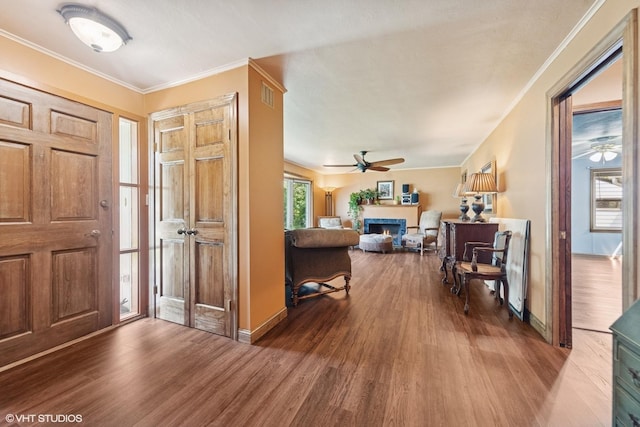 359 N Shady Ln, Elmhurst, IL 60126 - foyer entrance featuring ceiling fan, a lit fireplace, wood finished floors, baseboards, and crown molding