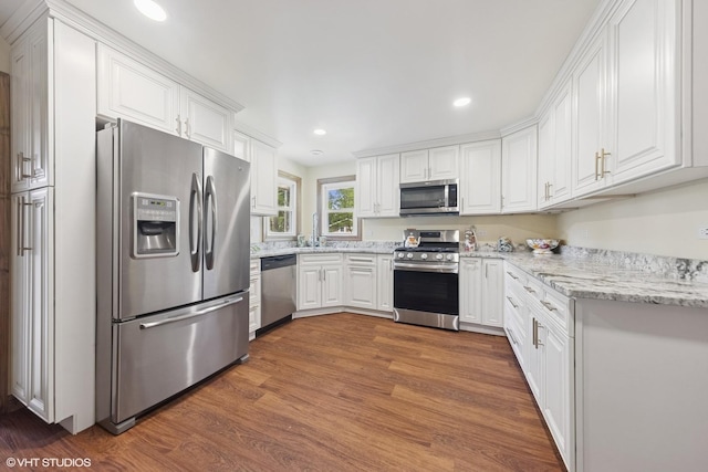 359 N Shady Ln, Elmhurst, IL 60126 - kitchen featuring appliances with stainless steel finishes, white cabinets, wood finished floors, light stone counters, and recessed lighting