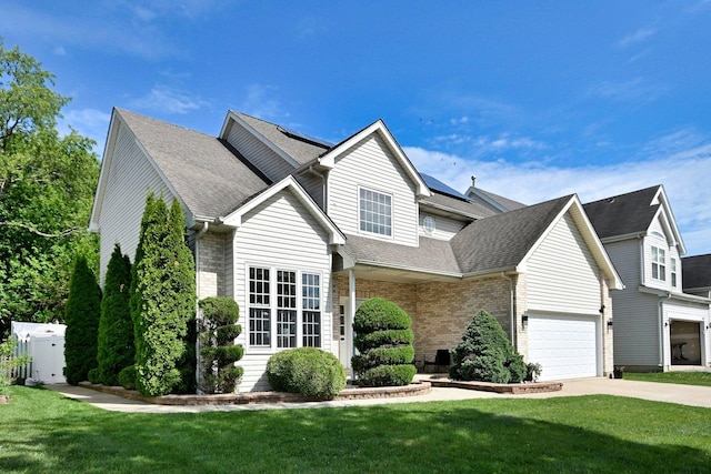 1422 Deer Creek Ln, Lake In The Hills, IL 60156 - traditional-style home featuring a front yard, solar panels, driveway, roof with shingles, and brick siding