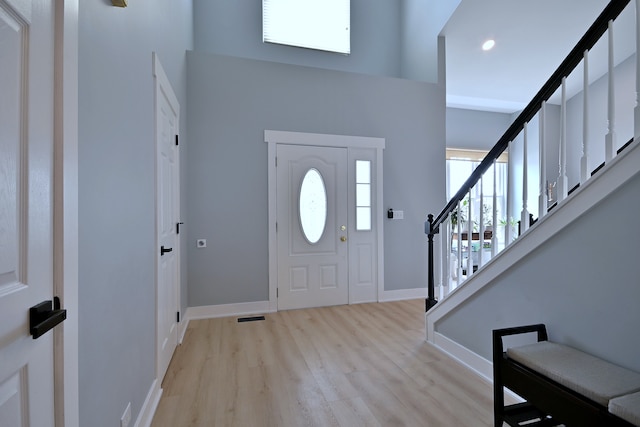1422 Deer Creek Ln, Lake In The Hills, IL 60156 - entrance foyer featuring light wood-type flooring, stairs, baseboards, a towering ceiling, and recessed lighting