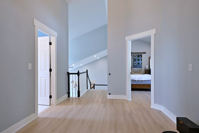 1422 Deer Creek Ln, Lake In The Hills, IL 60156 - hallway with a towering ceiling, wood finished floors, baseboards, and an upstairs landing