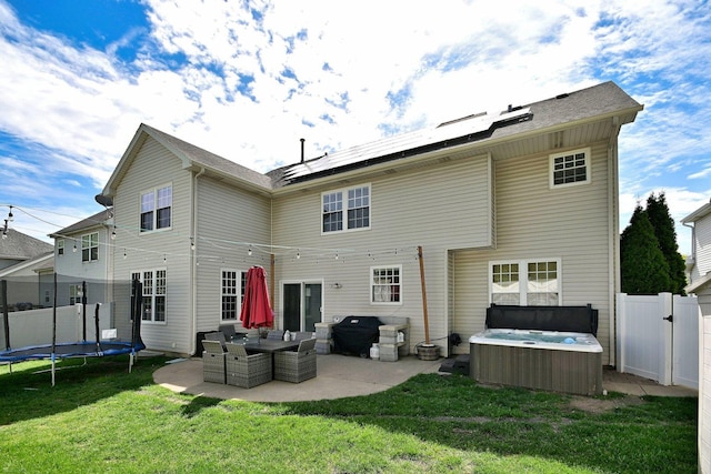 1422 Deer Creek Ln, Lake In The Hills, IL 60156 - back of house with a hot tub, a trampoline, a patio area, and solar panels