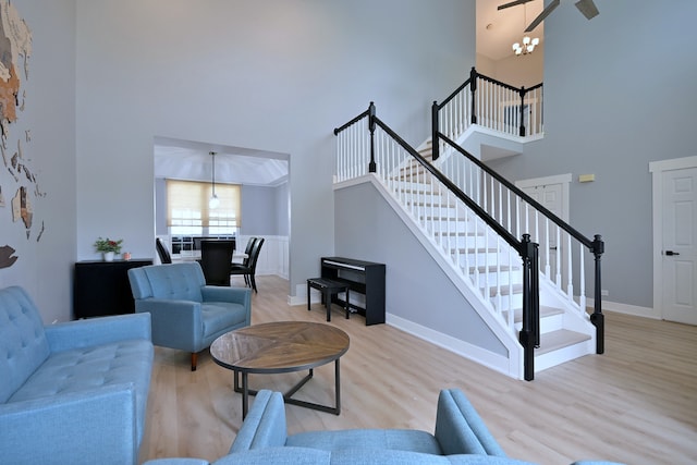 1422 Deer Creek Ln, Lake In The Hills, IL 60156 - living area with a high ceiling, wood finished floors, baseboards, a chandelier, and stairs
