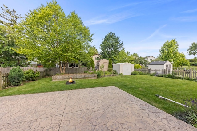 926 Navajo St, Carol Stream, IL 60188 - fenced backyard featuring a storage unit, an outdoor fire pit, and a patio area