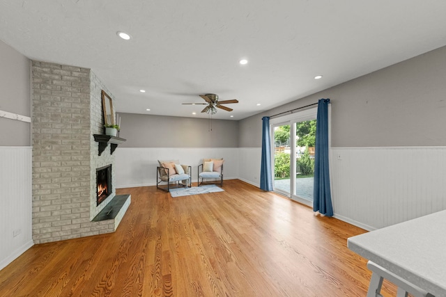 926 Navajo St, Carol Stream, IL 60188 - unfurnished living room with a wainscoted wall, ceiling fan, light wood finished floors, a brick fireplace, and recessed lighting