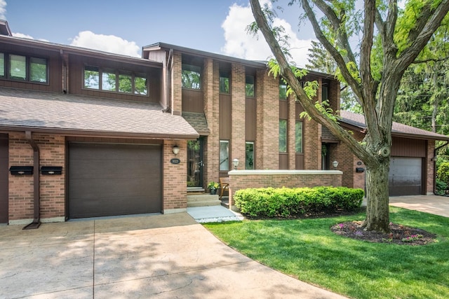 1023 Rene Ct, Park Ridge, IL 60068 - view of front of property featuring driveway, brick siding, a front lawn, and a garage