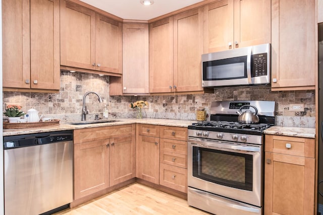 1023 Rene Ct, Park Ridge, IL 60068 - kitchen featuring appliances with stainless steel finishes, a sink, light stone countertops, tasteful backsplash, and light wood-type flooring