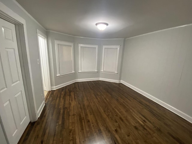 4224 N Kimball Ave, Chicago, IL 60618 - empty room with dark wood finished floors, baseboards, and ornamental molding