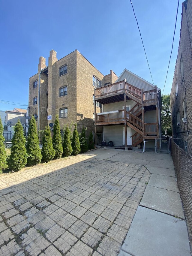 4224 N Kimball Ave, Chicago, IL 60618 - exterior space with stairway, a patio, a wooden deck, and a garage