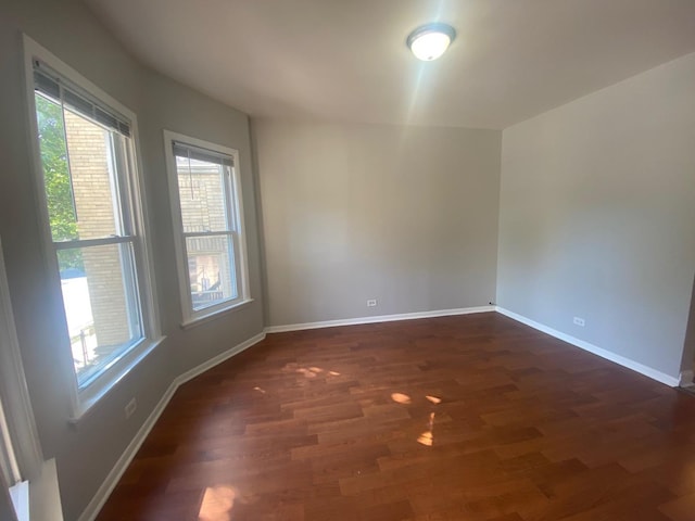 4224 N Kimball Ave, Chicago, IL 60618 - spare room with healthy amount of natural light, dark wood finished floors, and baseboards