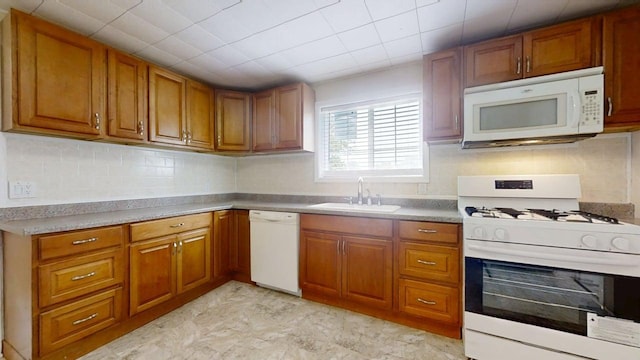 418 S Main St, Rankin, IL 60960 - kitchen featuring white appliances, brown cabinets, and decorative backsplash