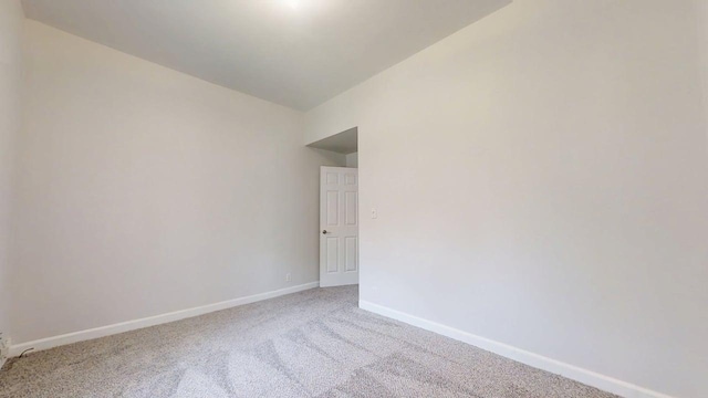418 S Main St, Rankin, IL 60960 - carpeted empty room featuring baseboards