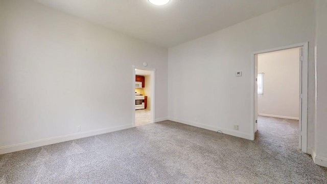 418 S Main St, Rankin, IL 60960 - carpeted spare room featuring baseboards
