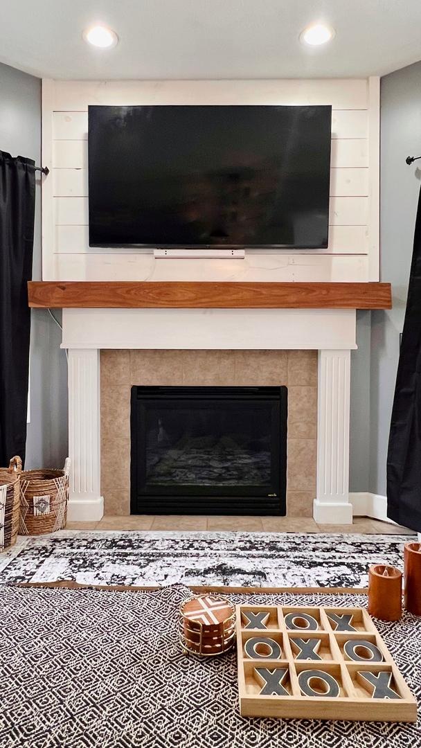 2703 Westbrook Dr, Bloomington, IL 61705 - detailed view of a tile fireplace, baseboards, and recessed lighting