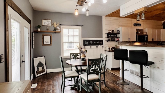 2703 Westbrook Dr, Bloomington, IL 61705 - dining space featuring dark wood-type flooring and wood walls