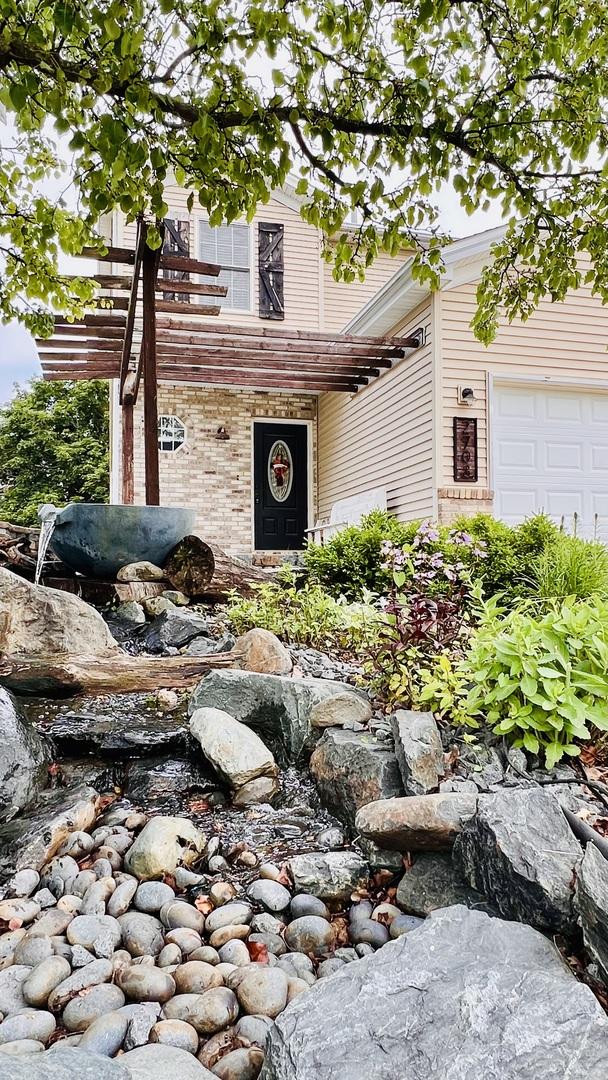 2703 Westbrook Dr, Bloomington, IL 61705 - view of front of property with brick siding and a garage