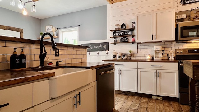 2703 Westbrook Dr, Bloomington, IL 61705 - kitchen with appliances with stainless steel finishes, a sink, decorative backsplash, and butcher block countertops