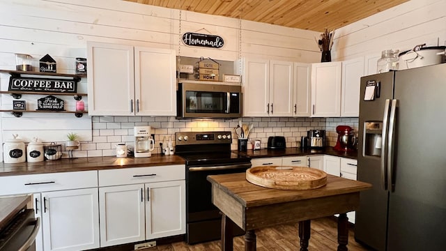 2703 Westbrook Dr, Bloomington, IL 61705 - kitchen featuring appliances with stainless steel finishes, wooden walls, decorative backsplash, wood ceiling, and dark wood finished floors