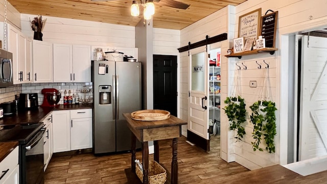 2703 Westbrook Dr, Bloomington, IL 61705 - kitchen featuring stainless steel refrigerator with ice dispenser, wooden ceiling, a barn door, dark countertops, and black / electric stove
