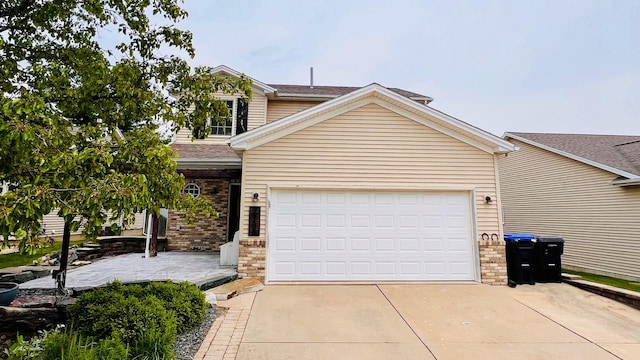2703 Westbrook Dr, Bloomington, IL 61705 - view of front facade featuring driveway, brick siding, and an attached garage