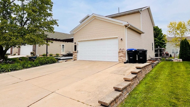 2703 Westbrook Dr, Bloomington, IL 61705 - view of side of property featuring a yard, driveway, an attached garage, and brick siding