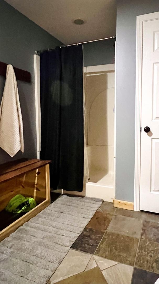 2703 Westbrook Dr, Bloomington, IL 61705 - bathroom with a stall shower and stone finish floors