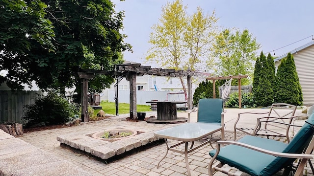 2703 Westbrook Dr, Bloomington, IL 61705 - fenced backyard with an outdoor fire pit, a pergola, and a patio area