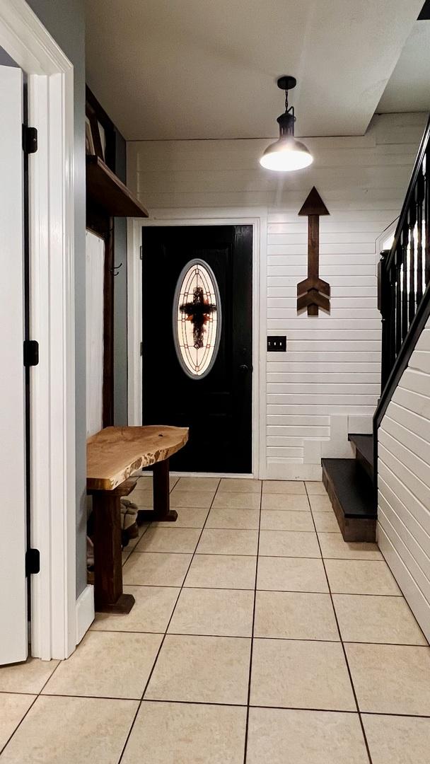 2703 Westbrook Dr, Bloomington, IL 61705 - mudroom with light tile patterned flooring and wooden walls