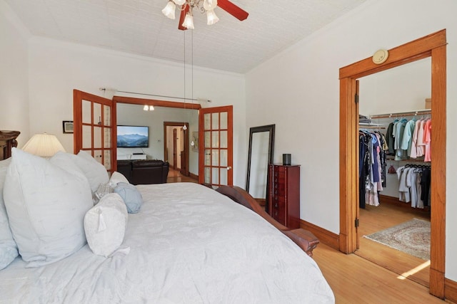 2559 N Saint Louis Ave, Chicago, IL 60647 - bedroom featuring french doors, wood finished floors, ornamental molding, a spacious closet, and a closet