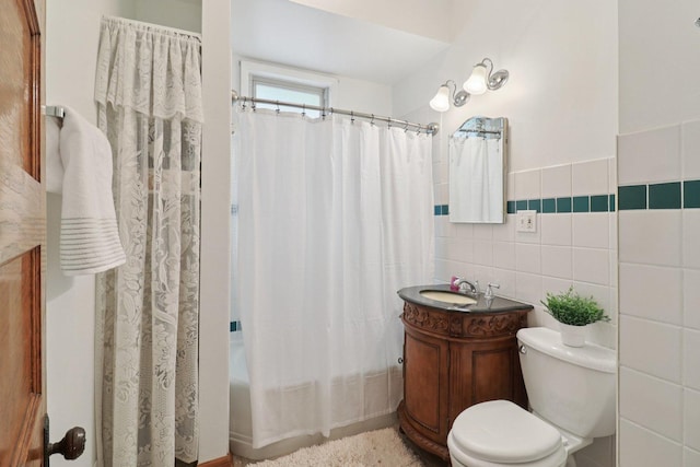 2559 N Saint Louis Ave, Chicago, IL 60647 - bathroom featuring vanity, shower / bath combo with shower curtain, and tile walls