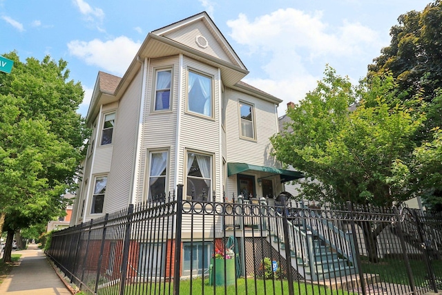 2559 N Saint Louis Ave, Chicago, IL 60647 - victorian home with a fenced front yard and stairway