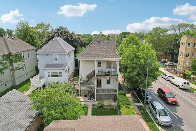 2559 N Saint Louis Ave, Chicago, IL 60647 - back of property with stairs, covered porch, and roof with shingles