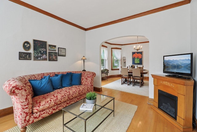 2559 N Saint Louis Ave, Chicago, IL 60647 - living area featuring arched walkways, ornamental molding, hardwood / wood-style flooring, and a chandelier