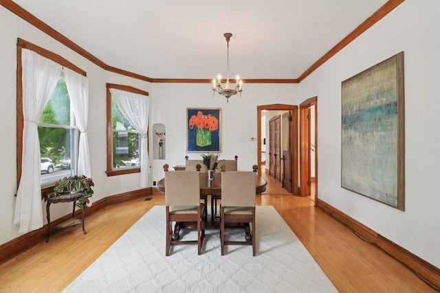 2559 N Saint Louis Ave, Chicago, IL 60647 - dining area featuring a chandelier, light wood-type flooring, and crown molding