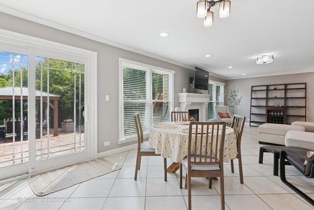 1981 White Oak Dr, Algonquin, IL 60102 - dining room featuring ornamental molding, healthy amount of natural light, light tile patterned floors, a warm lit fireplace, and recessed lighting