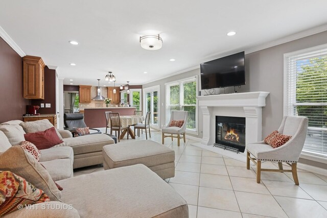 1981 White Oak Dr, Algonquin, IL 60102 - living area featuring crown molding, light tile patterned flooring, recessed lighting, a glass covered fireplace, and baseboards