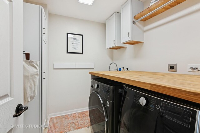 1981 White Oak Dr, Algonquin, IL 60102 - laundry area with cabinet space, washing machine and dryer, baseboards, and tile patterned floors