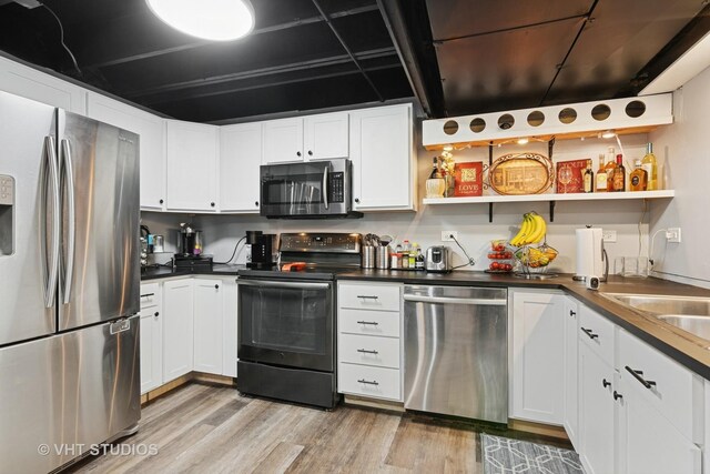 1981 White Oak Dr, Algonquin, IL 60102 - kitchen featuring stainless steel appliances, open shelves, light wood-style flooring, and white cabinetry