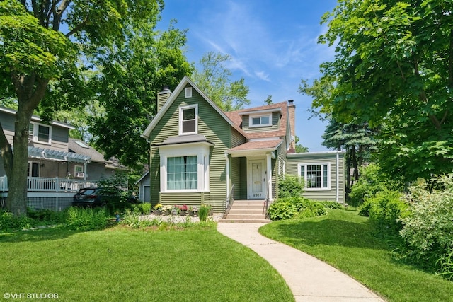2617 Thayer St, Evanston, IL 60201 - bungalow-style home with a chimney, a front yard, and roof with shingles
