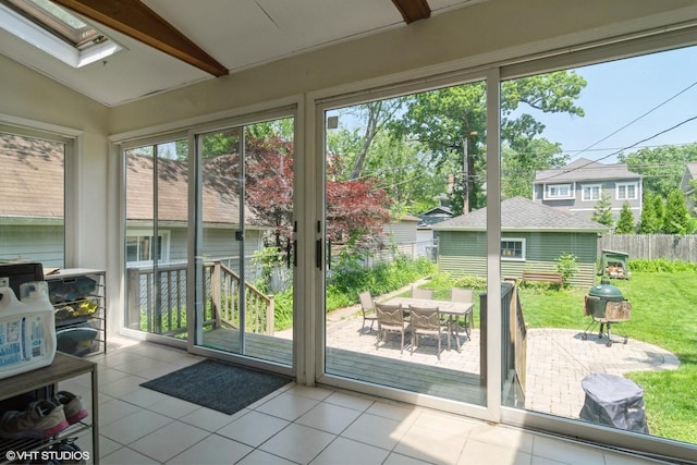 2617 Thayer St, Evanston, IL 60201 - doorway with a skylight, vaulted ceiling, and tile patterned floors