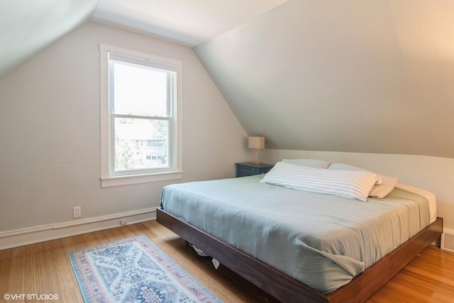 2617 Thayer St, Evanston, IL 60201 - bedroom featuring multiple windows, vaulted ceiling, and wood finished floors