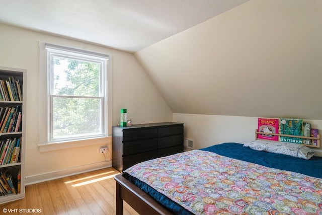 2617 Thayer St, Evanston, IL 60201 - bedroom with wood finished floors, multiple windows, and vaulted ceiling